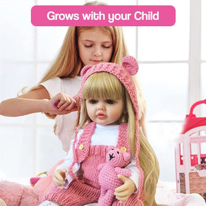 child playing with lifelike real-feel baby doll wearing pink knitted outfit and holding teddy bear