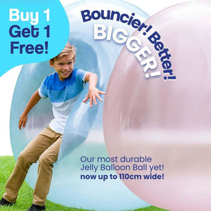 Child playing with large blue and pink Giant Jelly Balloon Ball outdoors
