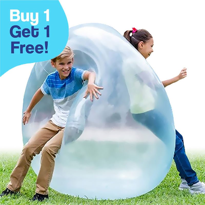 Kids playing outdoors with a transparent Giant Jelly Balloon Ball inflatable toy on grass