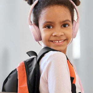 child wearing pink headset and backpack smiling, MP3 Player With Headset for kids with no internet connection, digital device for music and ebooks