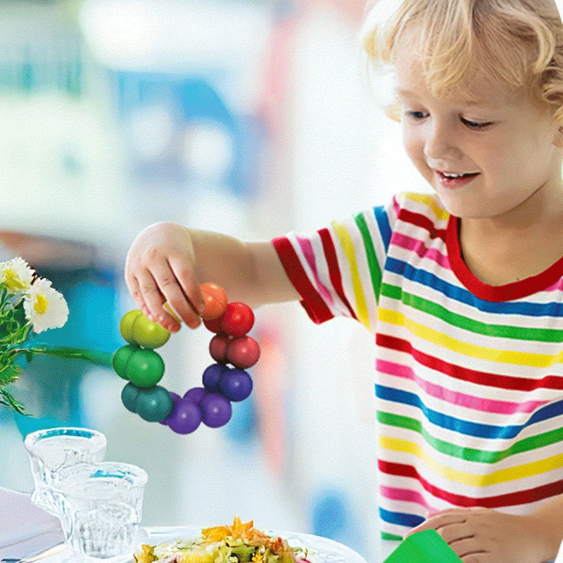 child playing with colorful screen-free busy bag toy at table