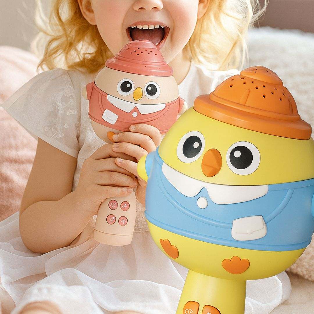 Child playing with colorful kids karaoke microphone and speaker toy designed as cute cartoon characters